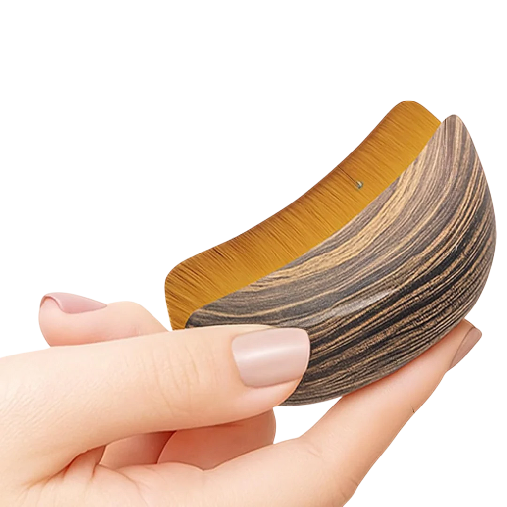 Brown curved face brush held in hand