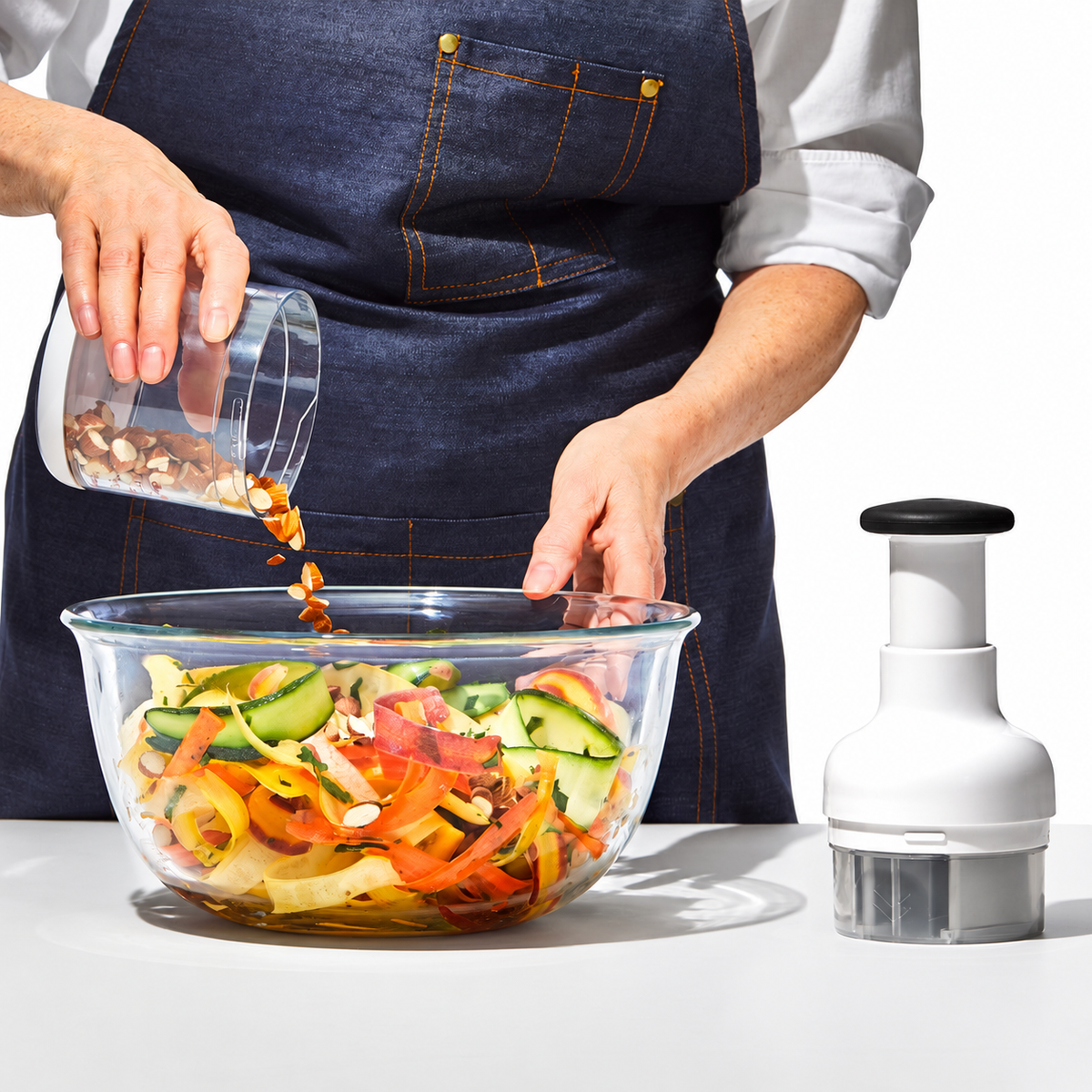 Chopped ingredients added to salad beside the chopper