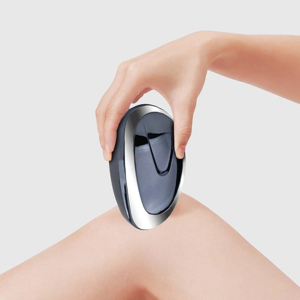 Dark blue hair-removal tool used on a leg