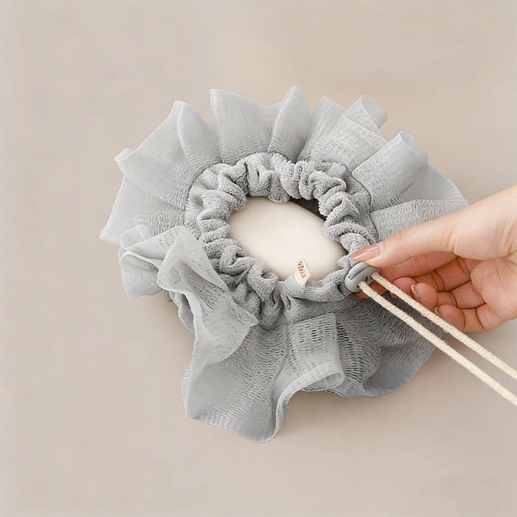 Gray Soap Loofah with its drawstring soap pocket held open