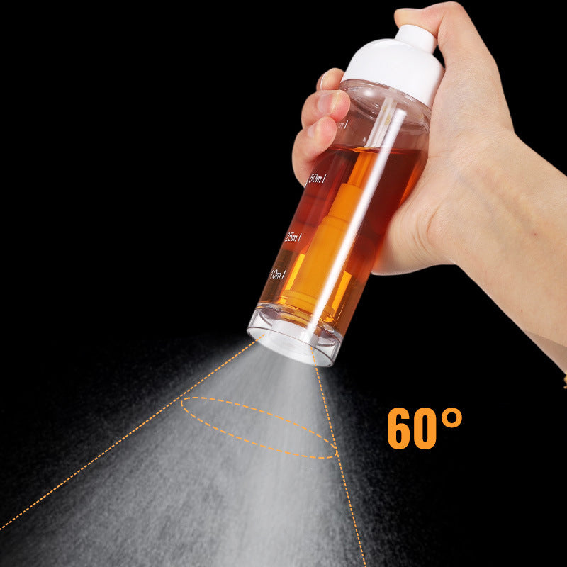 Hand pressing the top button of the cooking oil sprayer