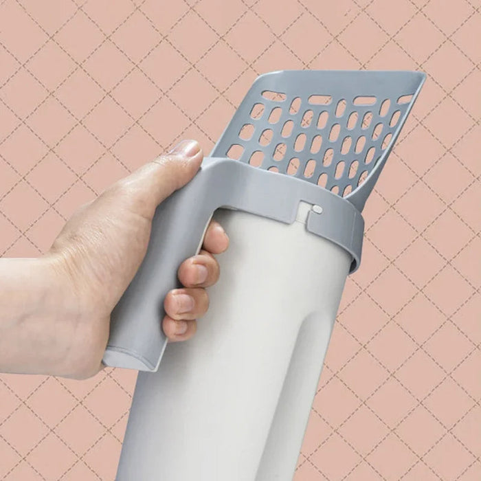Gray all-in-one cat litter scoop held in one hand