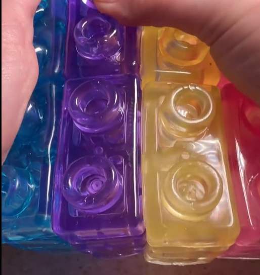 Close-up of round connecting studs on translucent building blocks