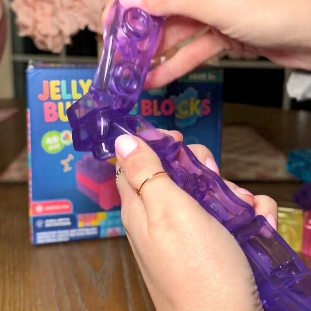 A purple jelly building block bent by hand