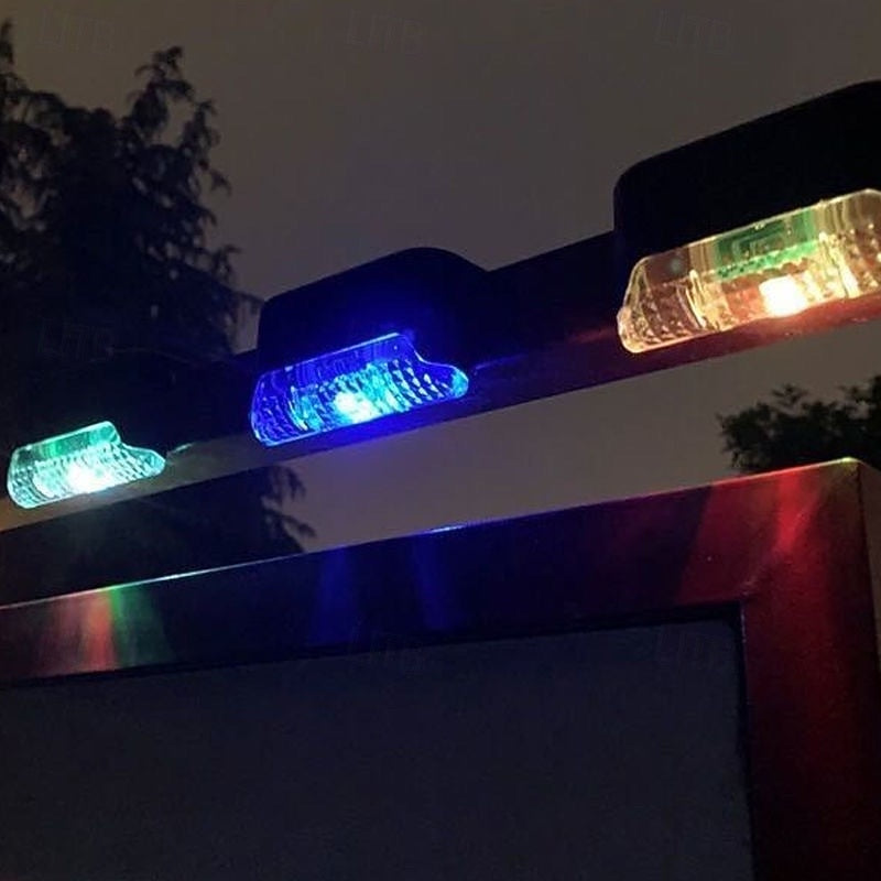 Colorful solar lights along an outdoor railing at night