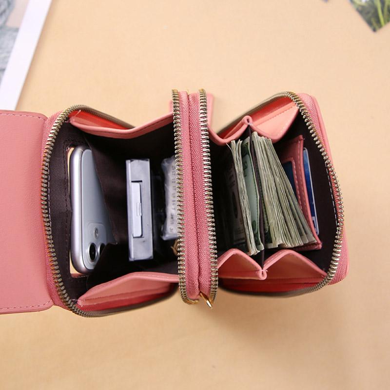 Phone, cards and cash arranged inside the bag