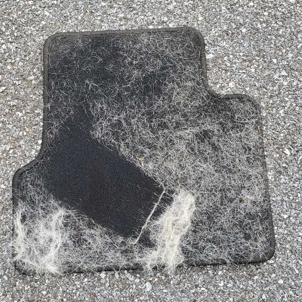 Pet hair gathered from a fabric car floor mat