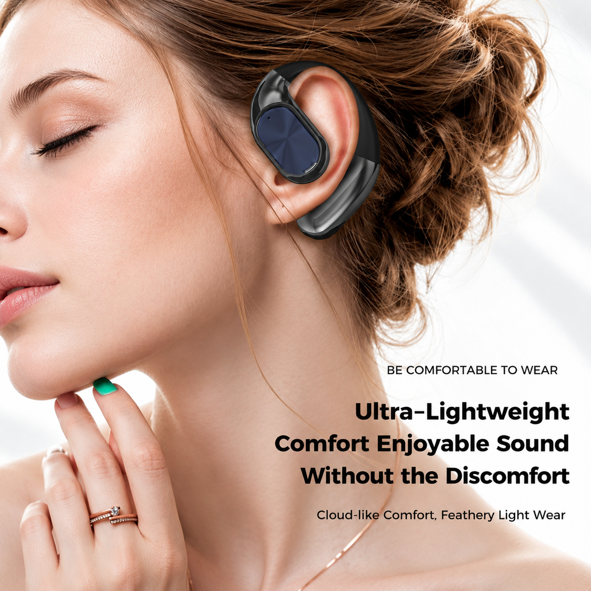 A person wearing a black open-ear earphone around the ear
