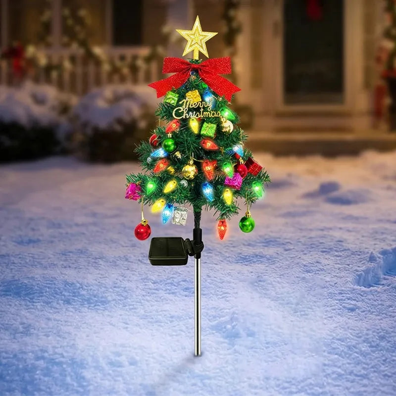 Green solar Christmas tree stake light outdoors