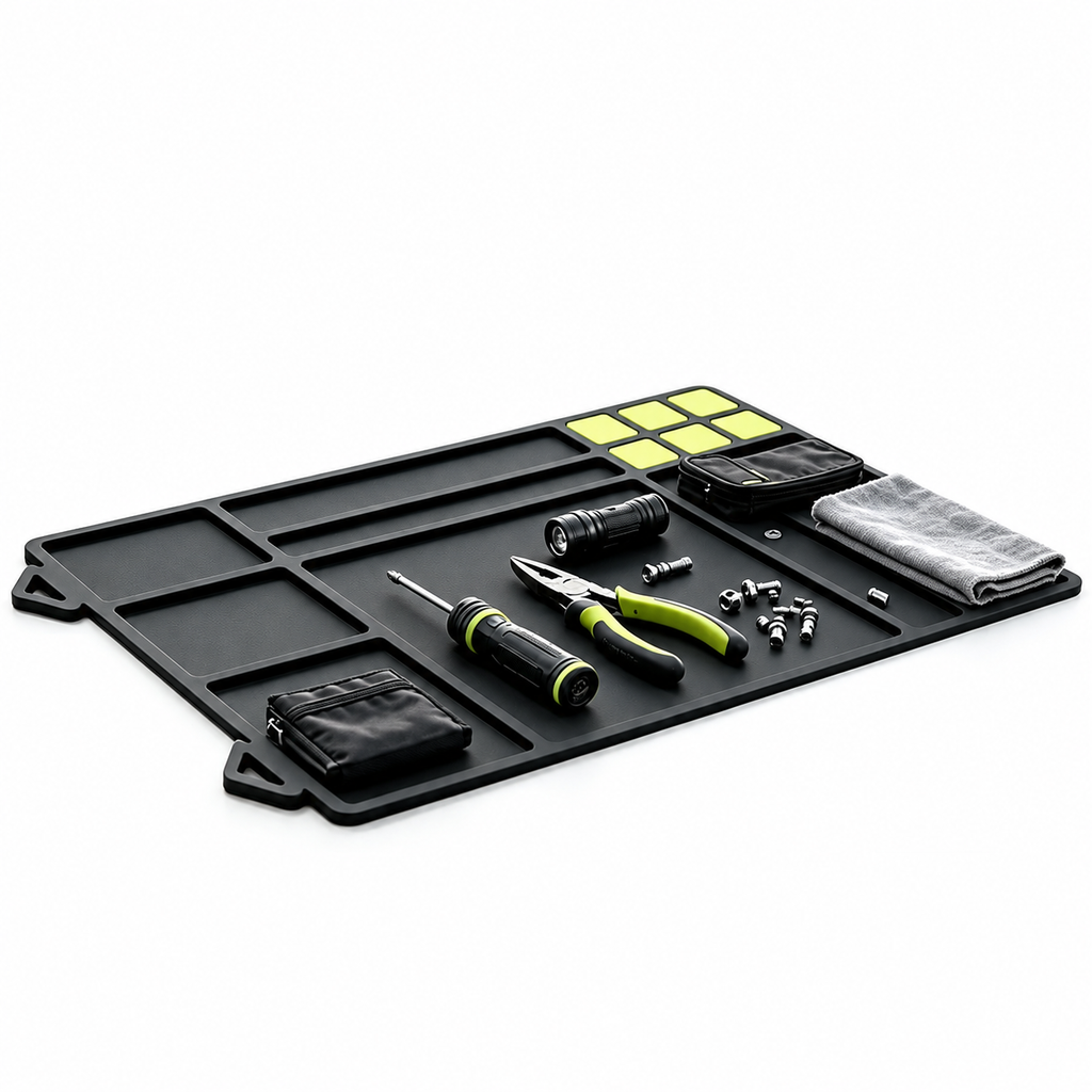 Black repair mat holding precision tools and small parts